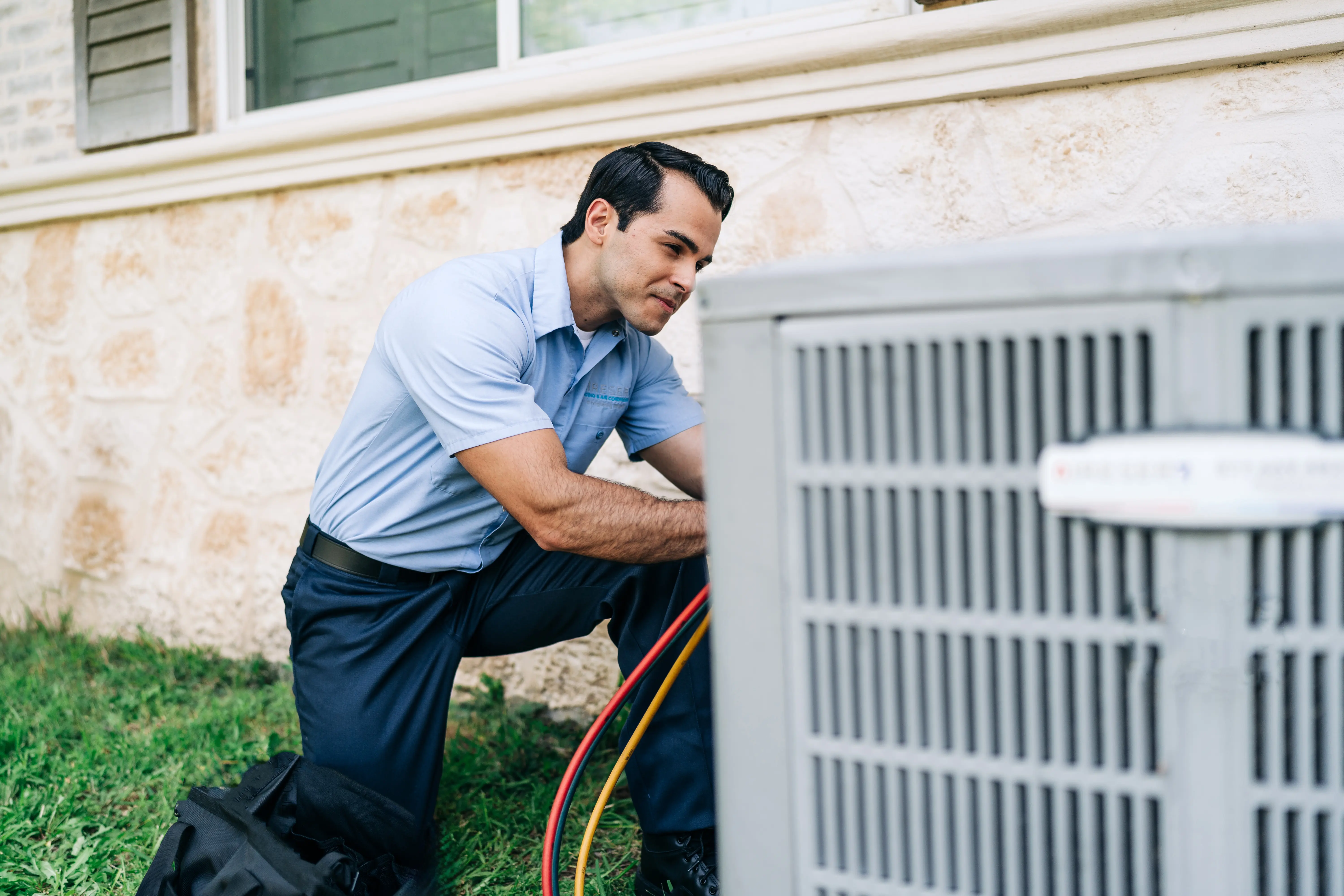 AireServ representative working on an outdoor AC unit.