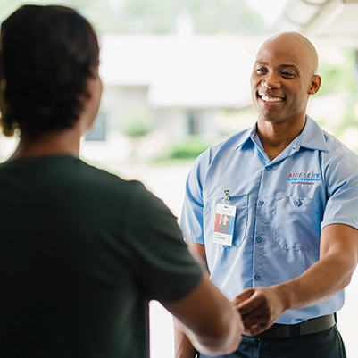 Aire Serv tech shaking hands with customer.