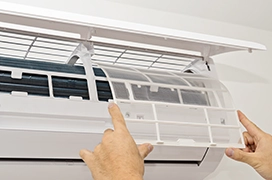 A picture of hands replacing an air filter.