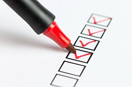 A picture of a red marker checking off items in a checklist.