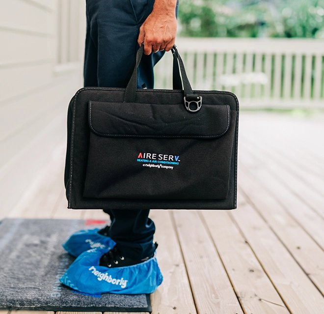 ASV technician holding a bag.