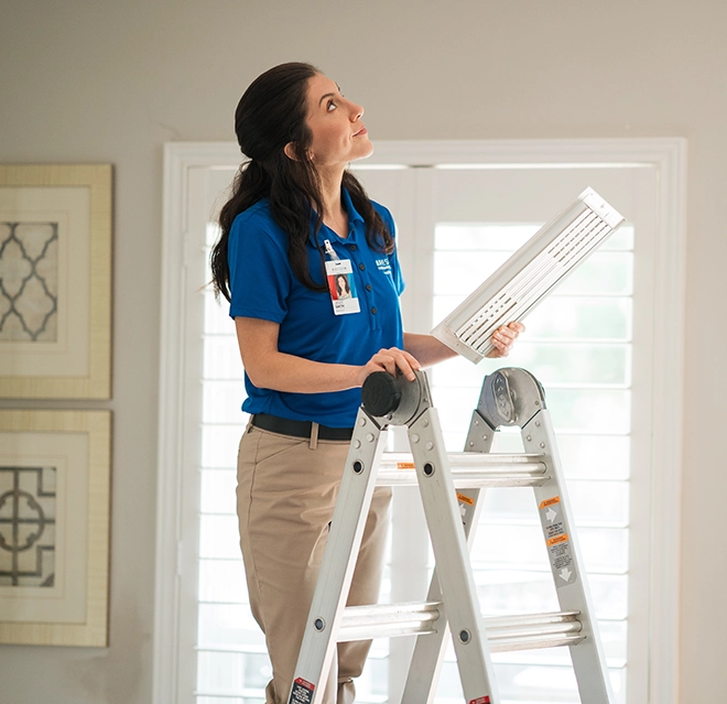 An asv technician checking the ceiling.