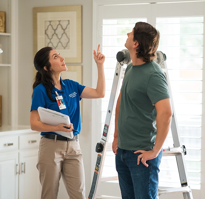 An asv technician explaining work to client.