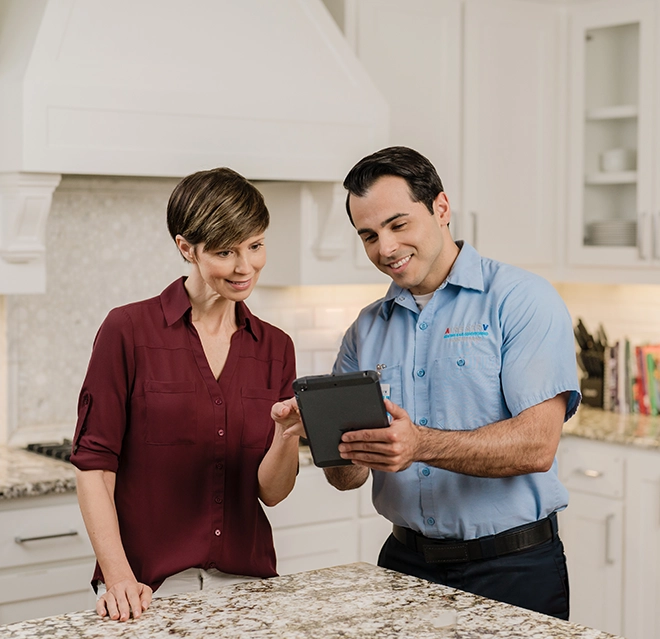 Aire Serv technician talking to a client.