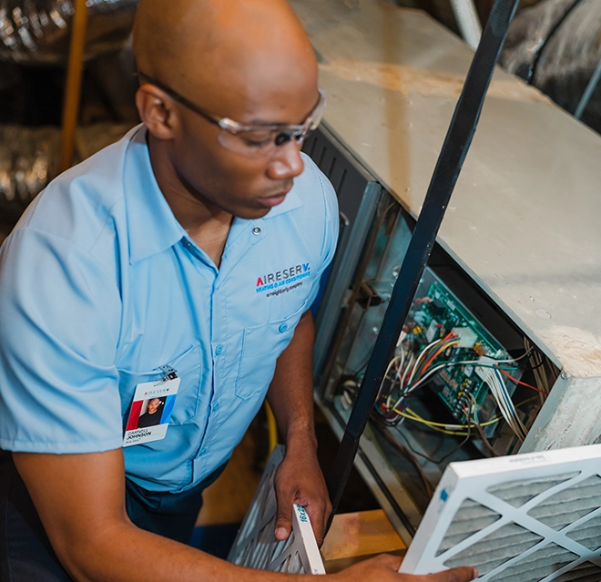 An asv technician changing airfilter.