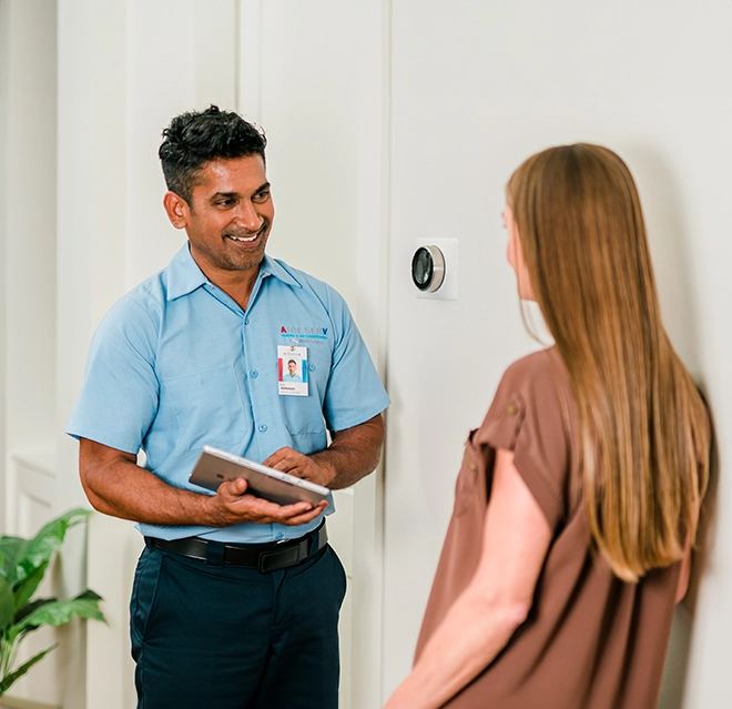 Aire Serv technician explaining services to the customer.