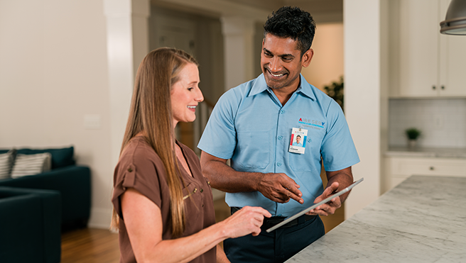 Aire Serv technician explaining various services to the customer.