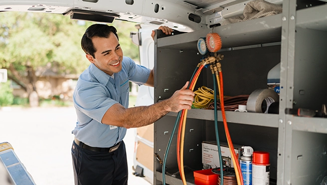 Aire Serv technician hanging the equipment.