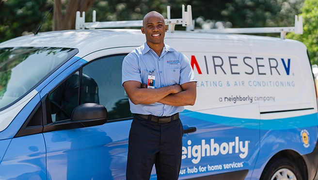 ASV technician in front of the brand van.