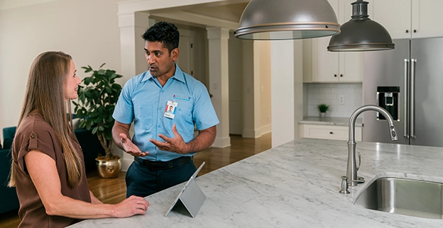 Aire Serv technician explaining services.