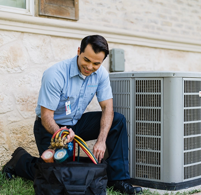 ASV technician working on the outdoor unit.