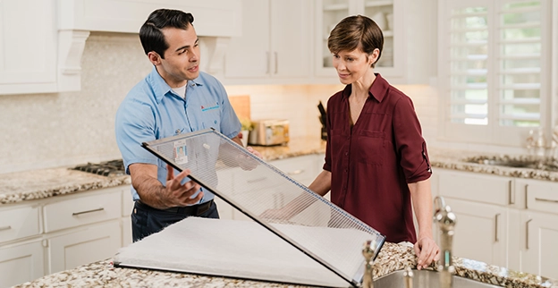 Aire Serv technician showing glass door window.