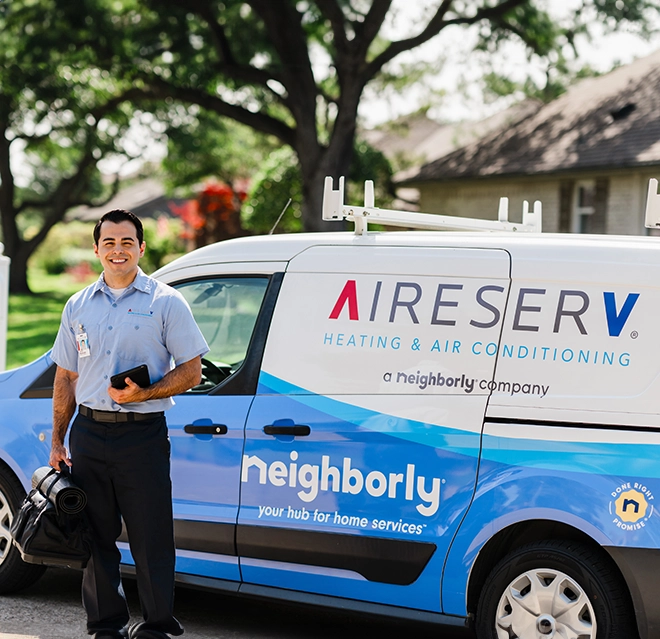 An asv technician standing beside a van with a toolkit.
