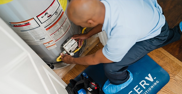ASV technician working on the water heater unit.