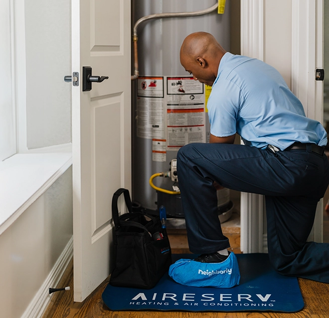 ASV technician working on the water heater.
