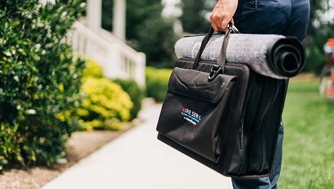 Aire Serv technician with tool bag.