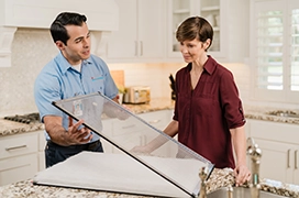 ASV technician showing glass door window to the customer.