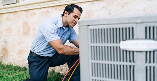 Aire Serv technician working on a customer's air conditioning unit.