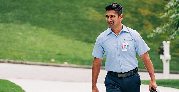 Aire Serv technician walking up to a customer's house.