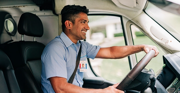 Aire Serv technician driving an Aire Serv van.