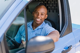 ASV Service Professional in van smiling.