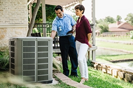 Aire Serv technician showing a customer an issue with their air conditioning unit.