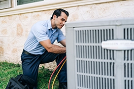 Aire Serv technician working on a customer's air conditioning unit.