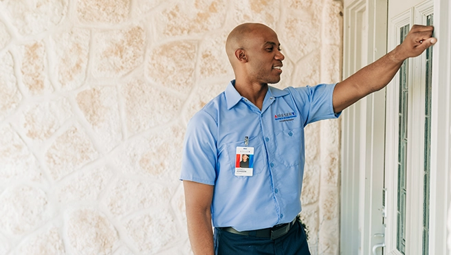 Aire Serv technician knocking on a customer's door.