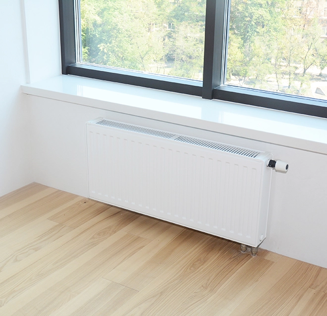A picture of a radiator beneath a window.