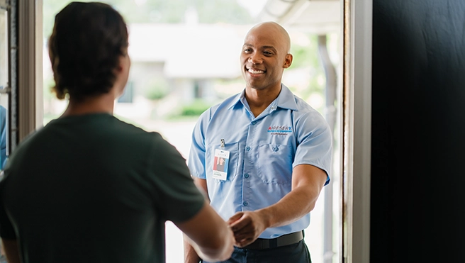 Aire Serv technician shaking a customer's hand.