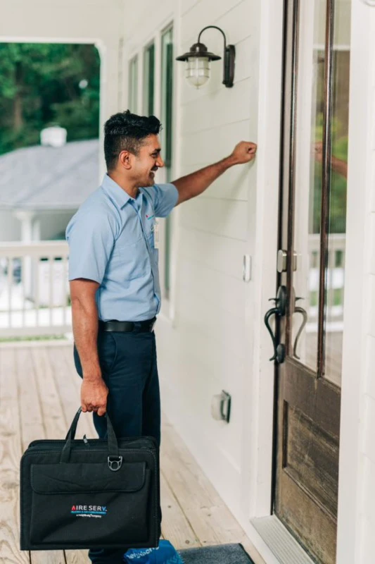 Aire Serv tech arriving to install an air filter at a residence.