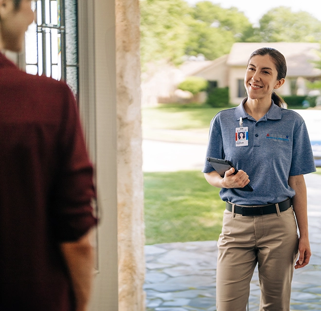 Aire Serv technician talking to a client.