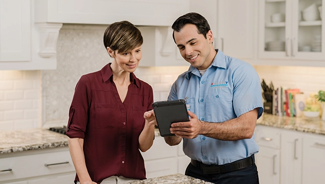 Aire Serv technician talking to a client.