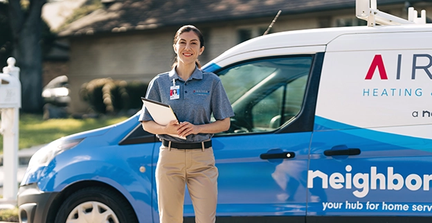 Aire Serv professional in front of an Aire Serv van.