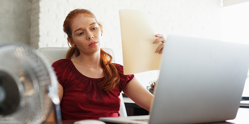 Woman working at a desk.