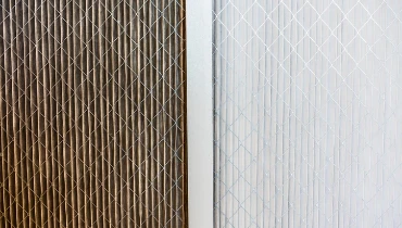 A side-by-side comparison of replacement air filters -- one dirty, one clean.