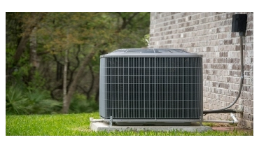 HVAC Air Conditioning Unit on concrete slap with new construction brick house