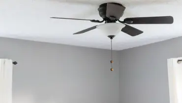 Ceiling fan in grey room