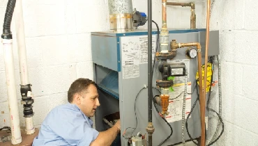 Technician checking a gas furnace
