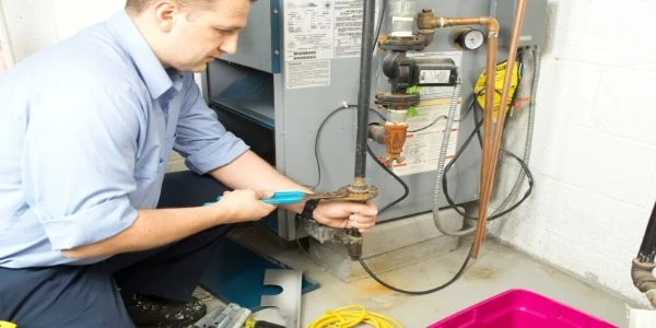 Technician repairing a gas furnace