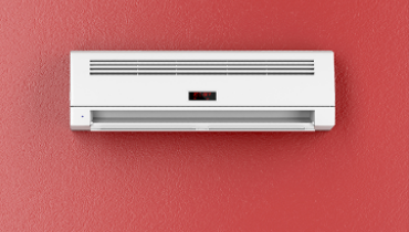 Ductless split unit mounted on red wall