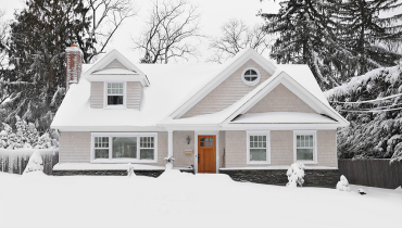 House in the middle of winter with snow on the ground
