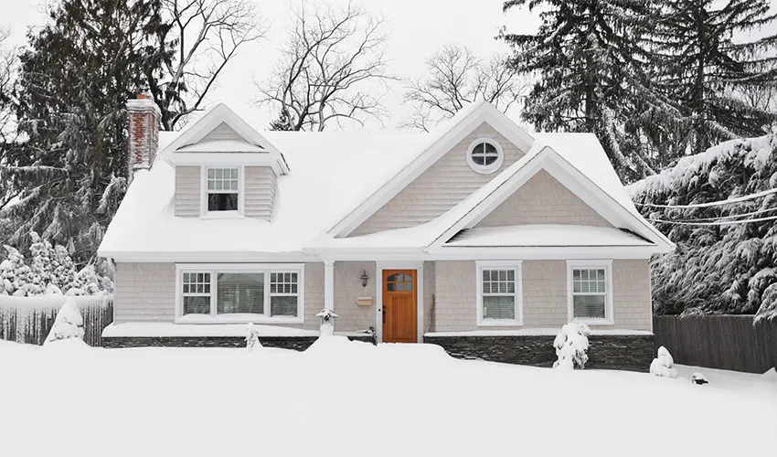 House in the middle of winter with snow on the ground