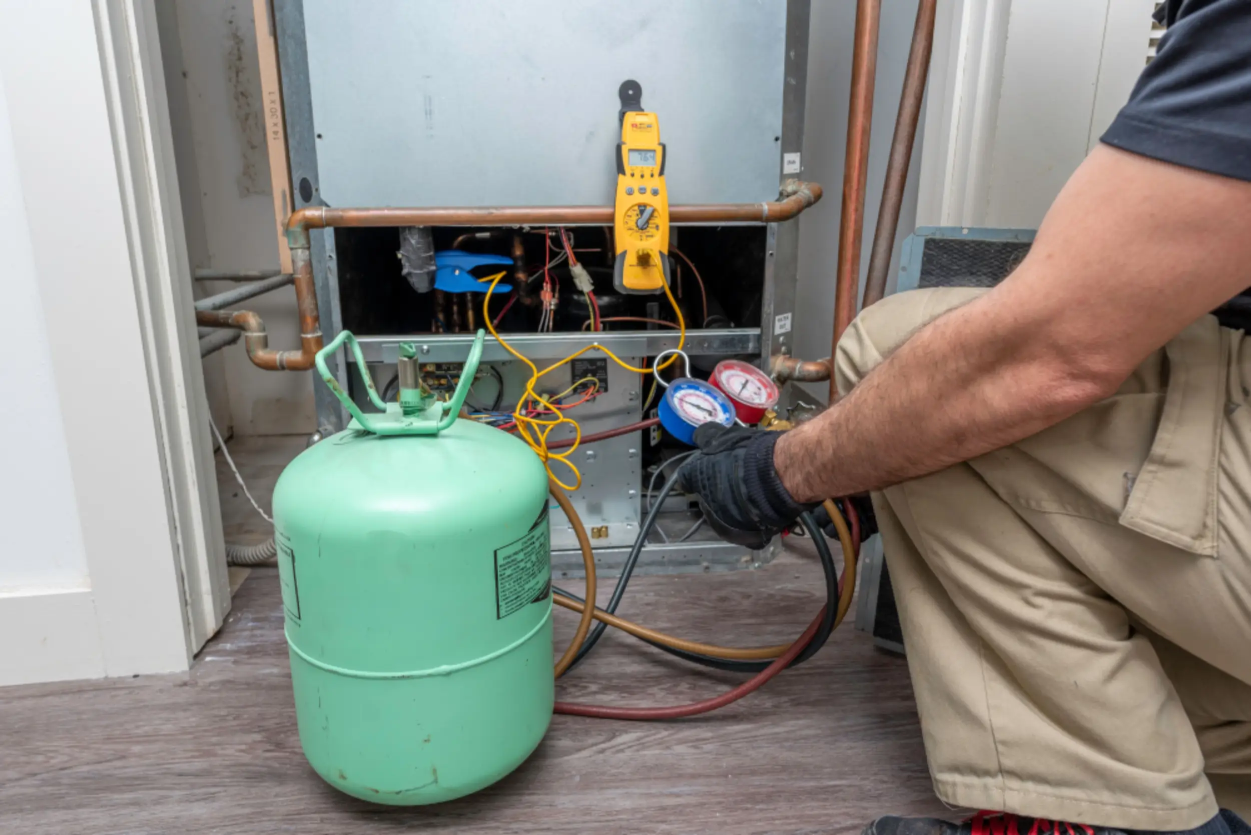 Aire Serv technician using refrigerant.