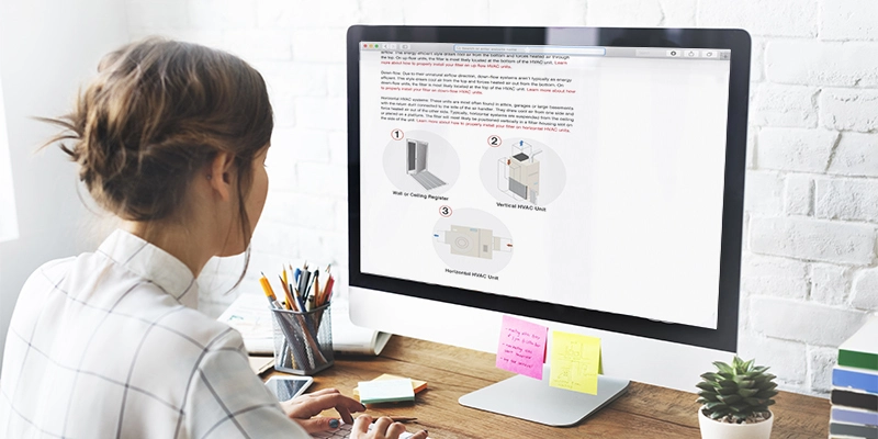 Woman staring at a computer screen at a neat desk